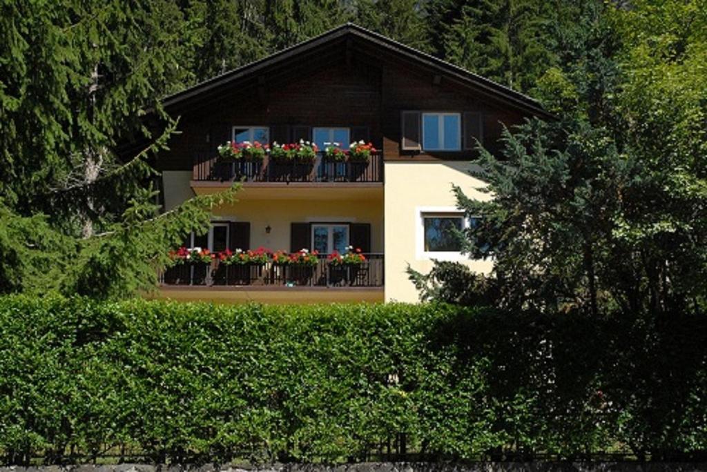 a house with flowers on a balcony at Haus Sabina in Siusi