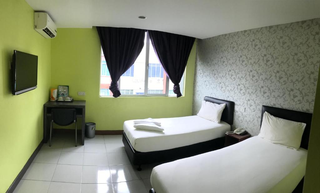 Postel nebo postele na pokoji v ubytování SARIKEI GARDEN HOTEL