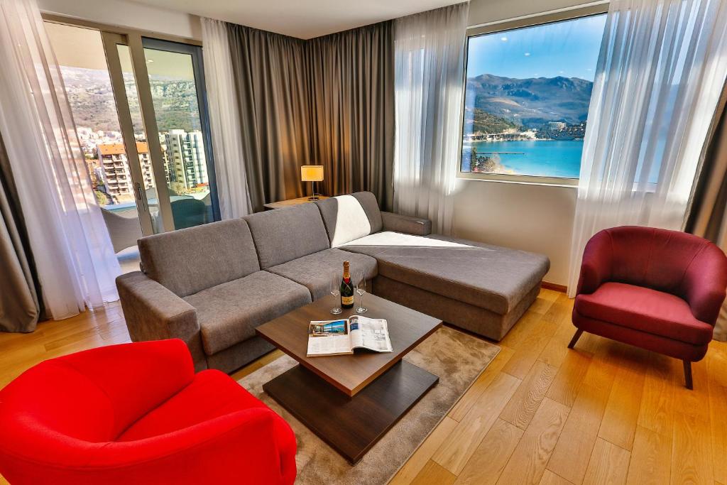 a living room with a couch and a red chair at Victoria Apartments in Budva