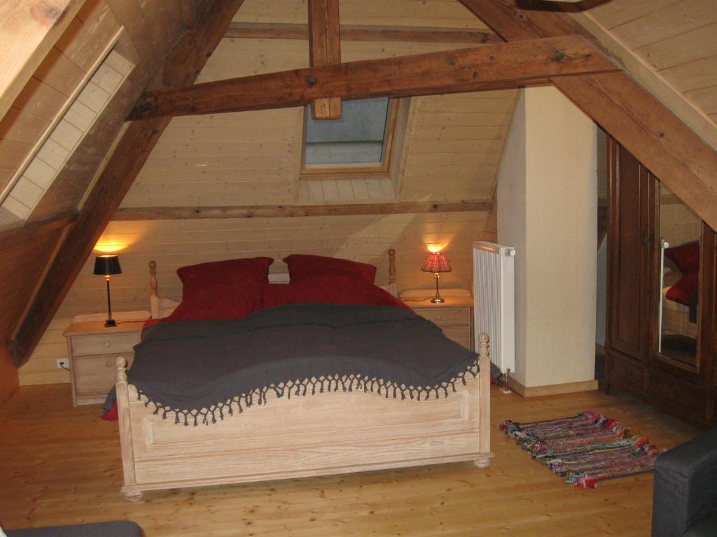 a bedroom with a large bed in a attic at Familiensuite, zwei Zimmer, Mitbenutzung von Küche und Bad in Rott