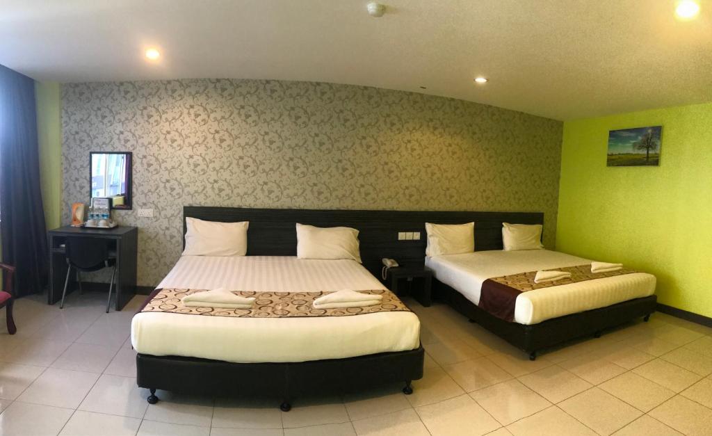 Postel nebo postele na pokoji v ubytování SARIKEI GARDEN HOTEL