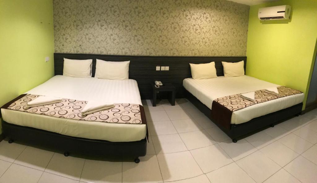 Postel nebo postele na pokoji v ubytování SARIKEI GARDEN HOTEL