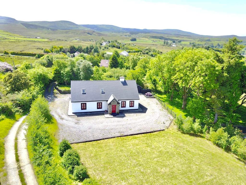 an aerial view of a white house in the countryside at Red Deer Cottage near Connemara National Park in Letterfrack in Letterfrack