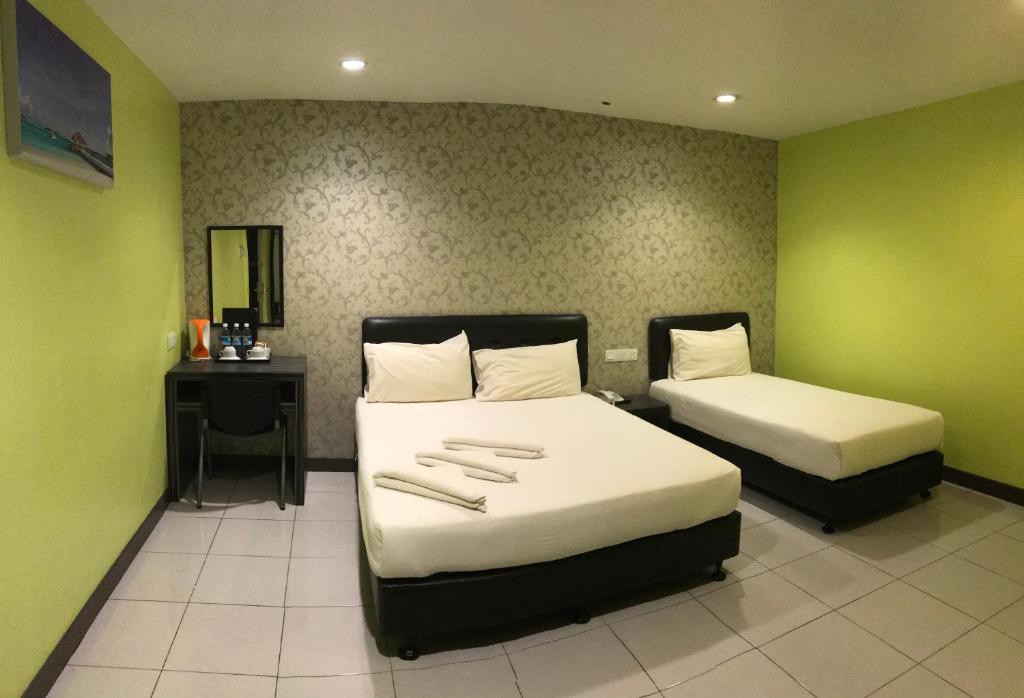 Postel nebo postele na pokoji v ubytování SARIKEI GARDEN HOTEL