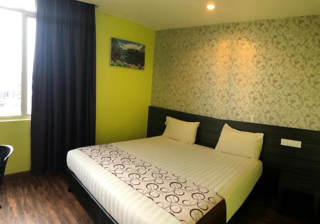 Postel nebo postele na pokoji v ubytování SARIKEI GARDEN HOTEL