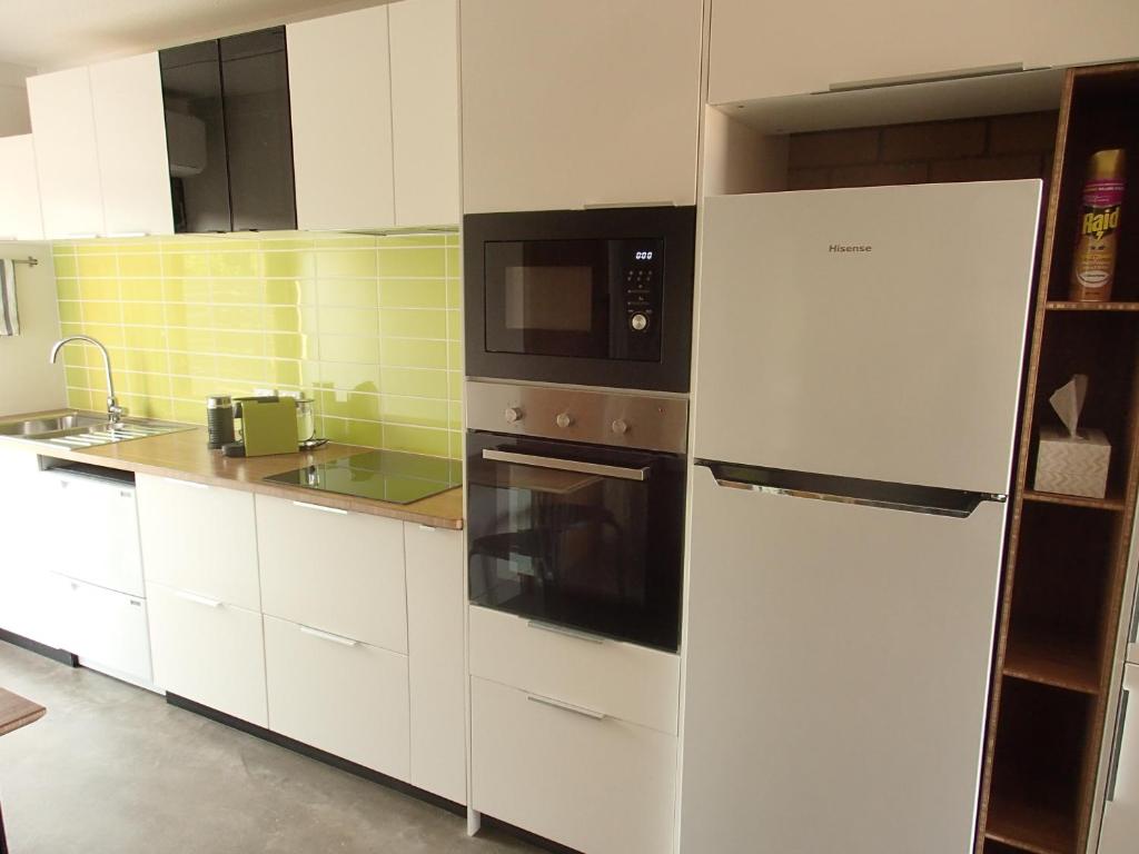 a kitchen with a white refrigerator and a microwave at Wahgunyah Motel in Wahgunyah