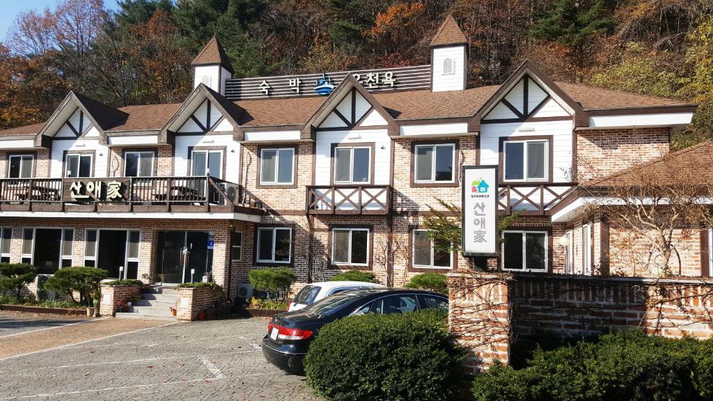 a house with a car parked in front of it at Sanaega Pension in Yangyang