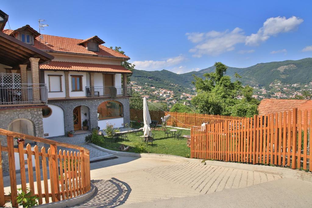 a house with a wooden fence in front of a yard at B&B Villa Italia in Agerola