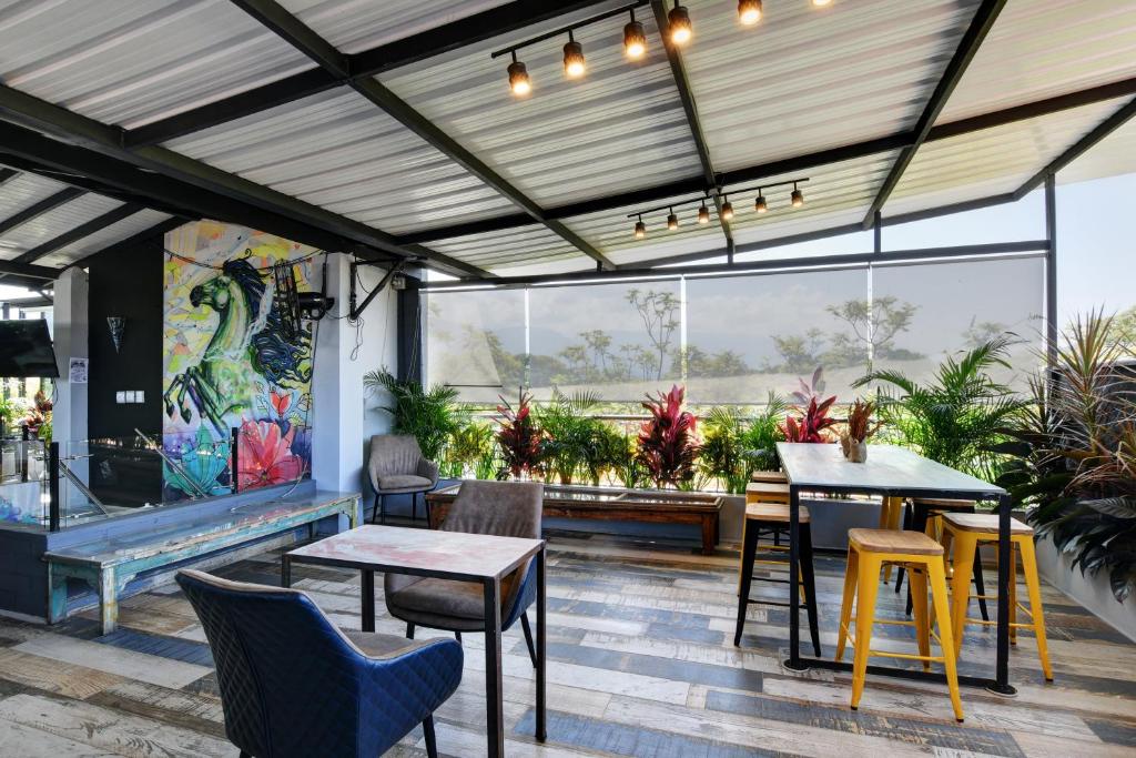 a patio with tables and chairs in a restaurant at International House Co-Living in Medellín