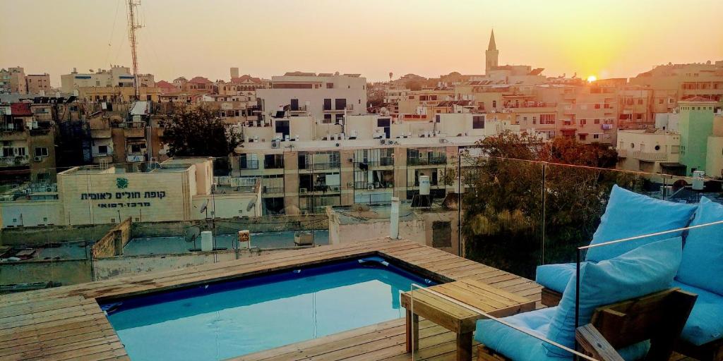 a swimming pool on the roof of a building at Old Jaffa's Penthouse Boutique Hostel in Tel Aviv