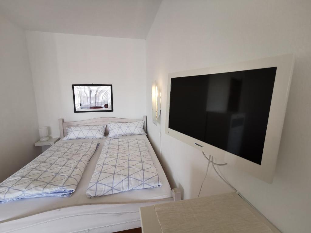 a bedroom with a bed with a flat screen tv at Apartment Bad Reichenhall in Bad Reichenhall