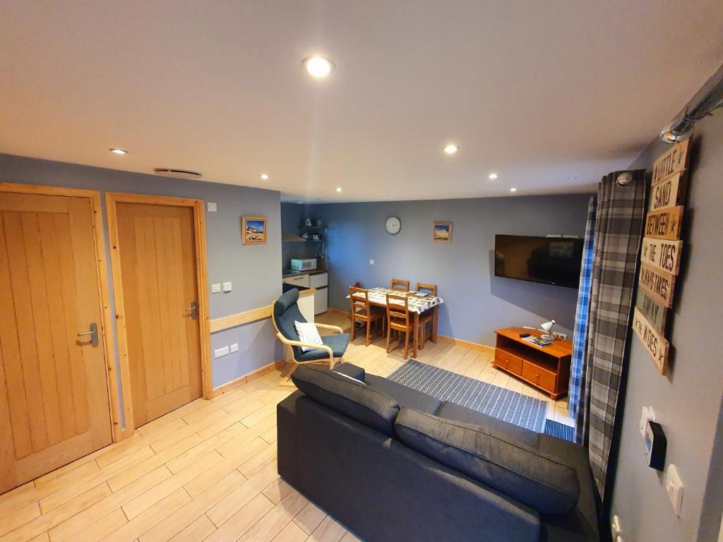 a living room with a couch and a table at 41 Tudor Court in Hayle