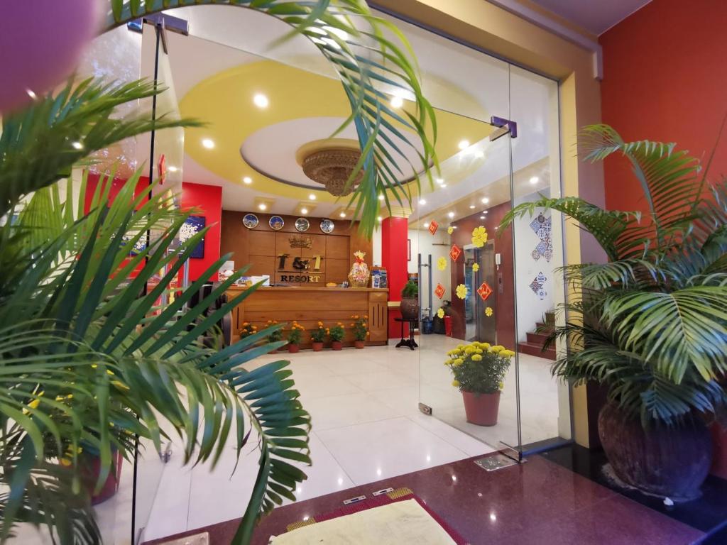 a lobby with potted plants in a building at T&T Resort And Spa in Phú Quốc