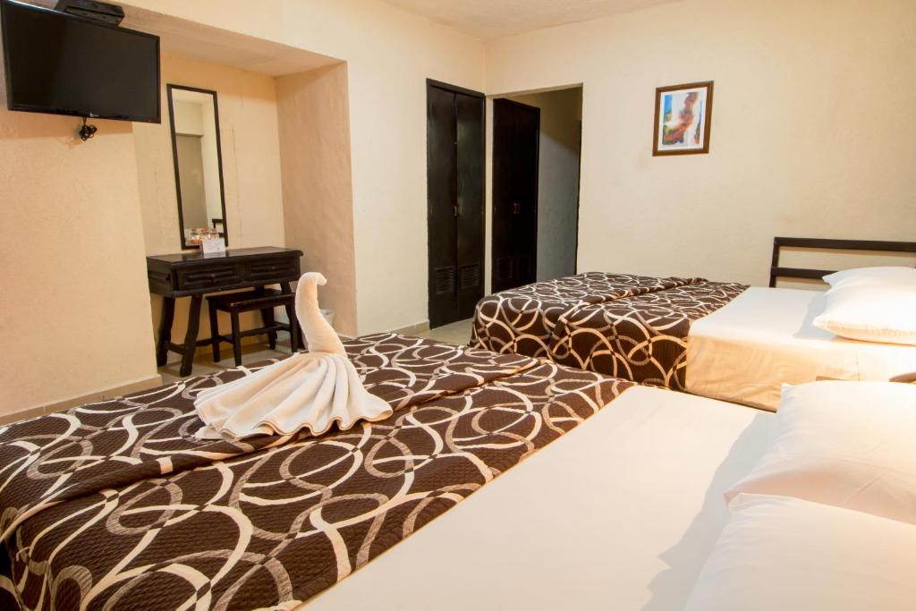 Postel nebo postele na pokoji v ubytování Hotel Colon Merida
