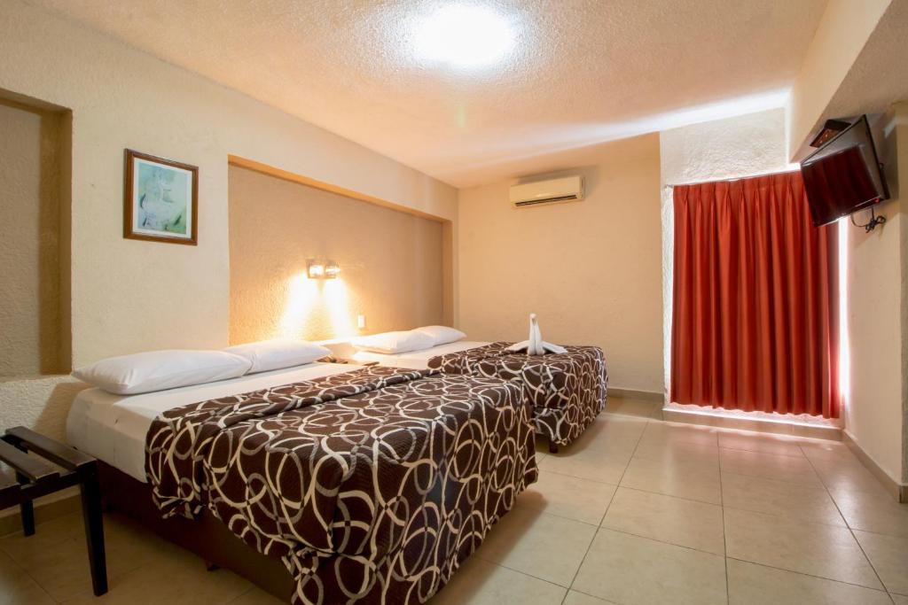 Postel nebo postele na pokoji v ubytování Hotel Colon Merida