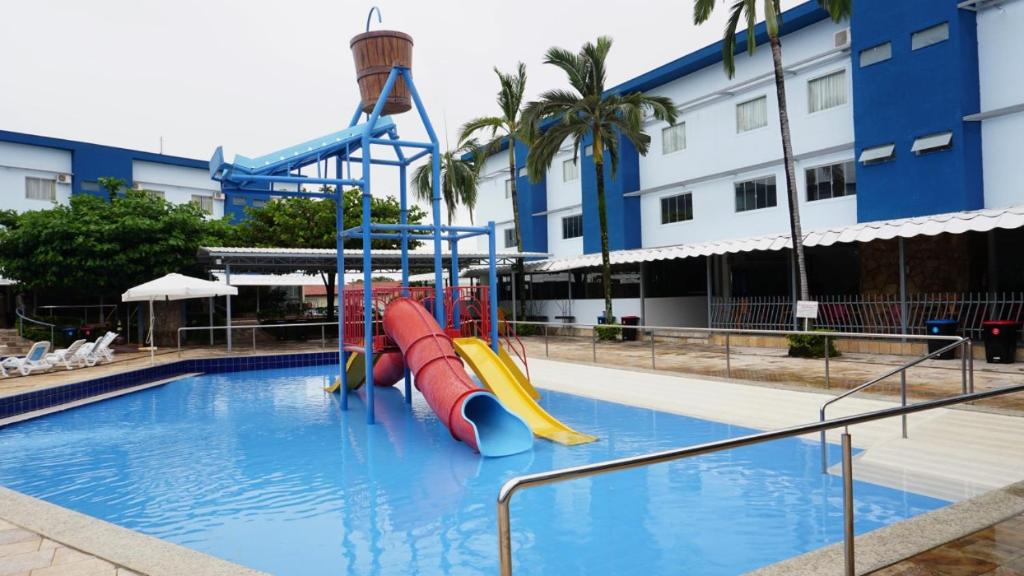 a swimming pool with a slide in a resort at Cafe e Almoço Hotel Thermas da Affego in Caldas Novas