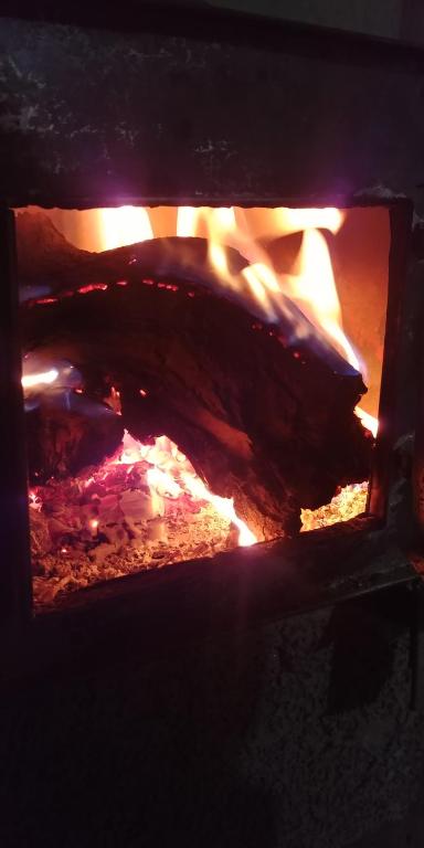 a brick oven with a fire in it at Gite Ifoulou Tassaout in Ifoulou