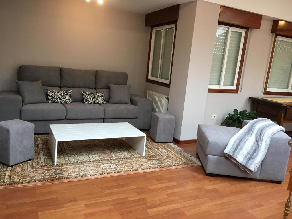 a living room with a couch and a coffee table at Duplex Rosalia De Castro. Ribadavia in Ribadavia