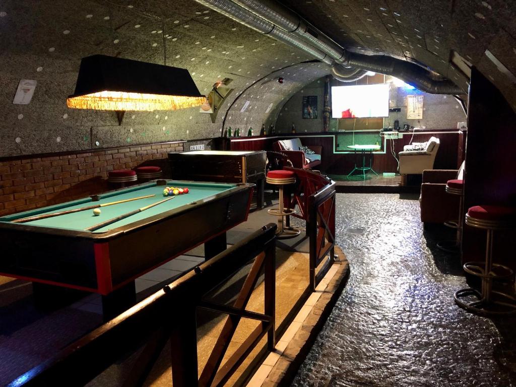 a room with a pool table and a bar at whole basement former pub 5 for Stag do in Budapest