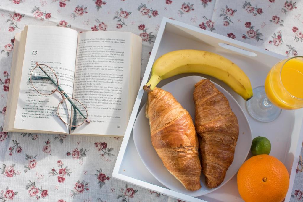 a lunch box with a banana and croissants and a book at Villa Lelas in Makarska