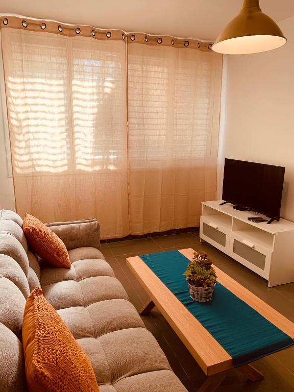 a living room with a couch and a tv at BEAUTIFUL PRIVATE in Beer Sheva