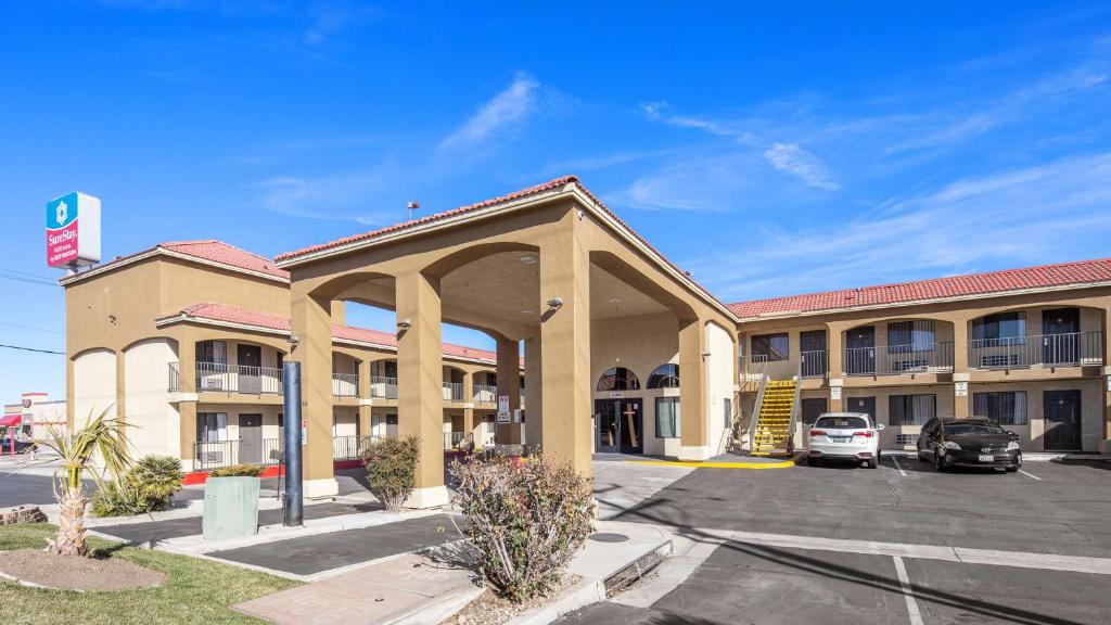 a hotel with a parking lot in front of it at SureStay Plus Hotel by Best Western Hesperia in Hesperia