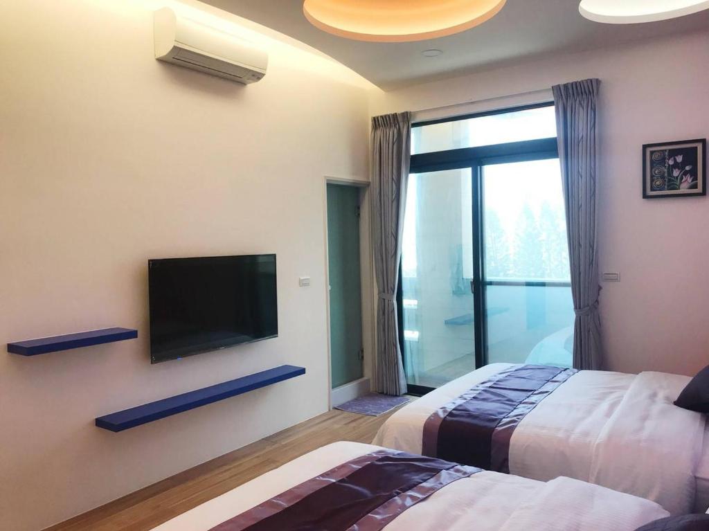 Postel nebo postele na pokoji v ubytování Purple Shell Homestay II