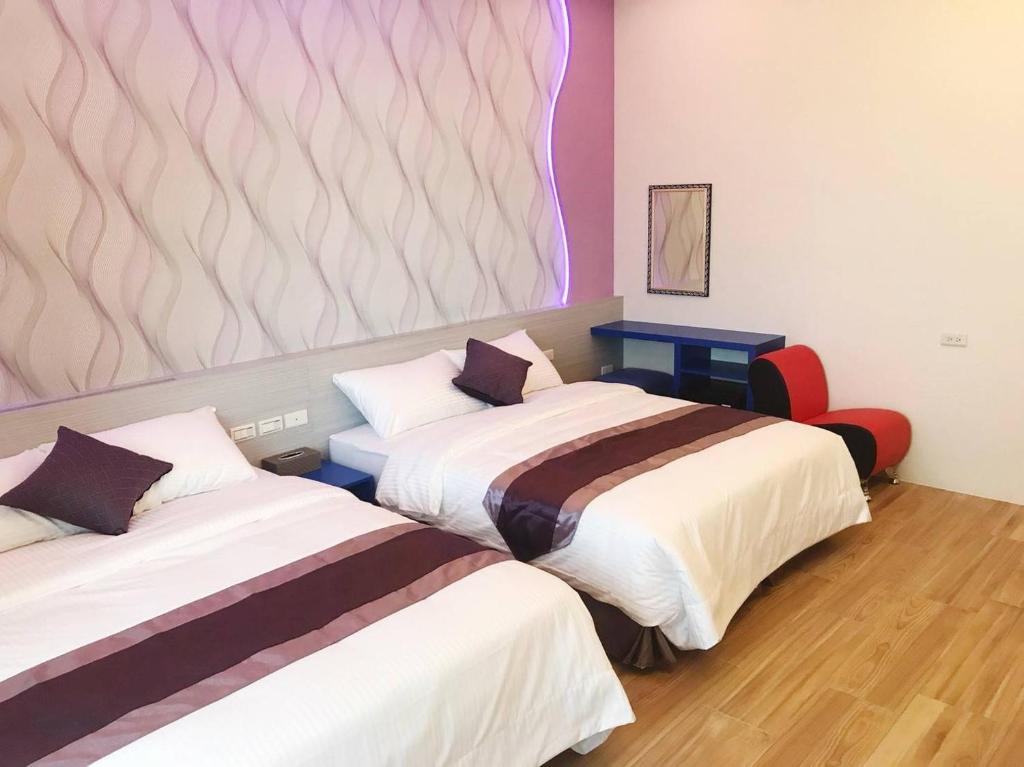 Postel nebo postele na pokoji v ubytování Purple Shell Homestay II