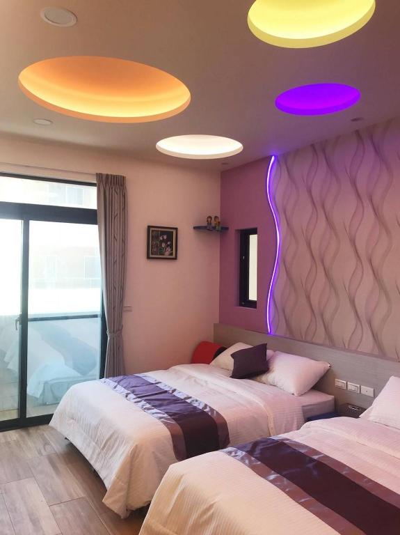 Postel nebo postele na pokoji v ubytování Purple Shell Homestay II