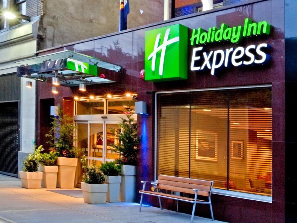 a store with a bench in front of a building at Holiday Inn Express - Times Square by IHG in New York