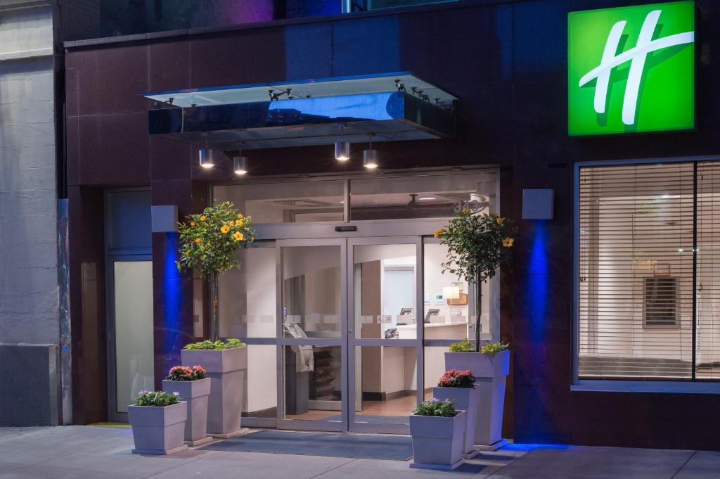 a front entrance to a building with potted plants at Holiday Inn Express - Times Square, an IHG Hotel in New York