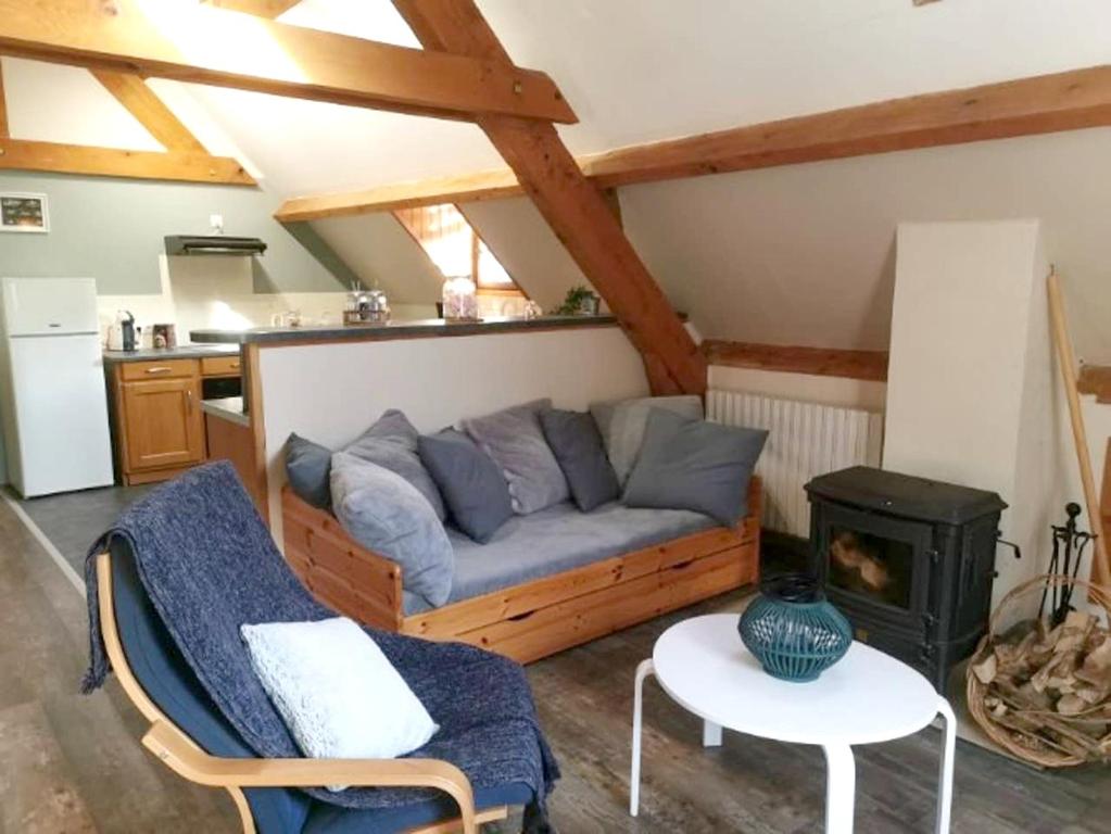 a living room with a couch and a stove at Chalet de 3 chambres avec sauna et wifi a Arrens Marsous in Arrens-Marsous