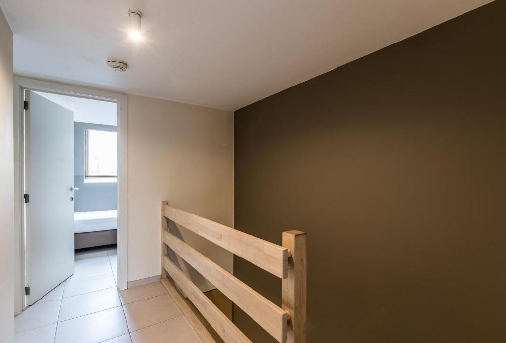 a hallway with a staircase in a house at Vakantiehuisje Walhofpark 10 in De Panne