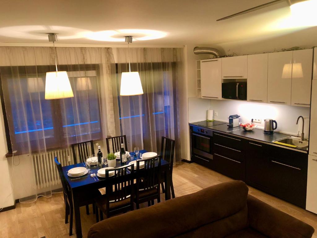 a kitchen and dining room with a table and chairs at Localita Polin 15, apartamenti 21 in Tione di Trento