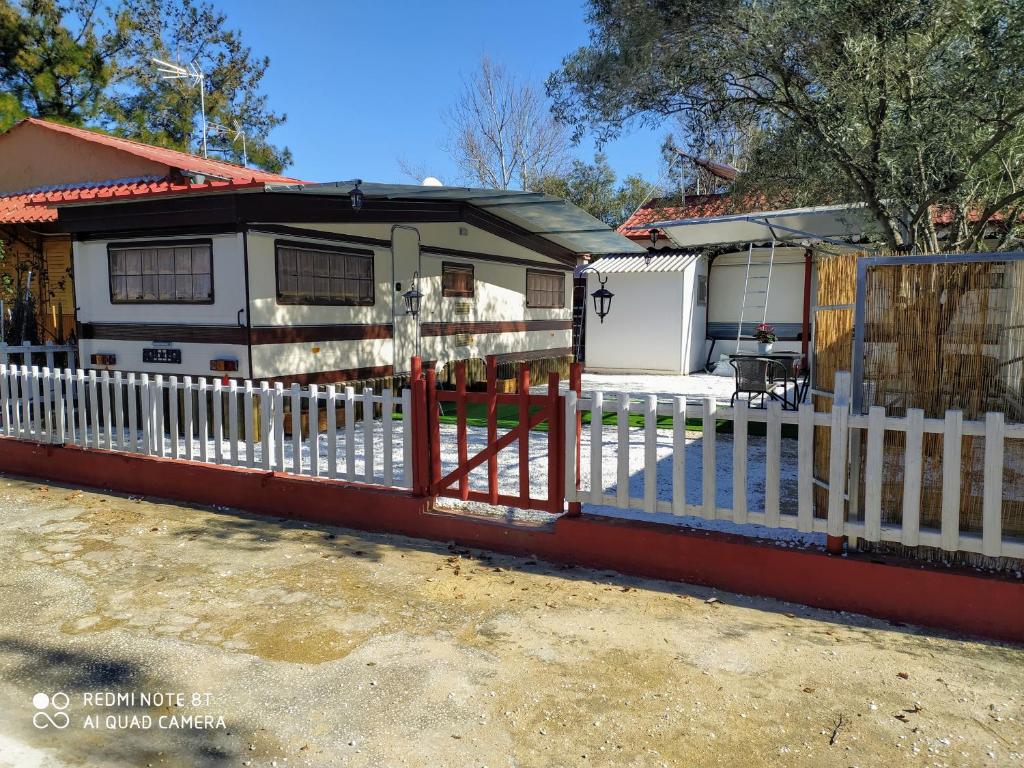 a white fence in front of a house at For Nature Lovers 2 in Skala Rachoniou