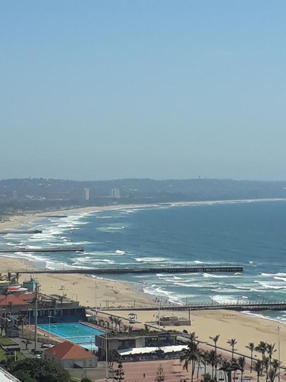 an aerial view of a beach and the ocean at Into The Blue on the Beach in Durban