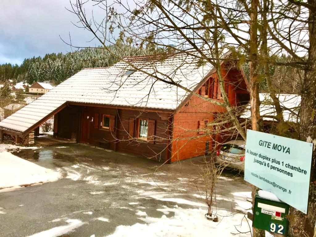 a house with a sign in front of it at gite moya in Gérardmer