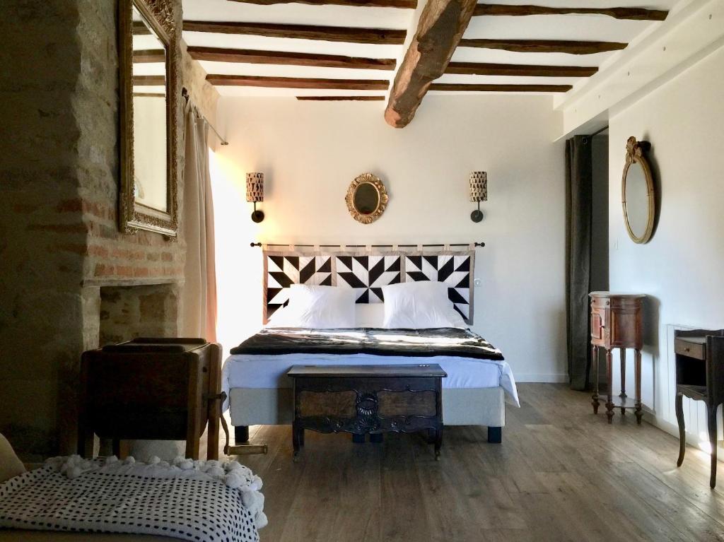 a bedroom with a bed in a room with a fireplace at HENRI& HENRIETTE le studiolo d'HENRI in Vannes