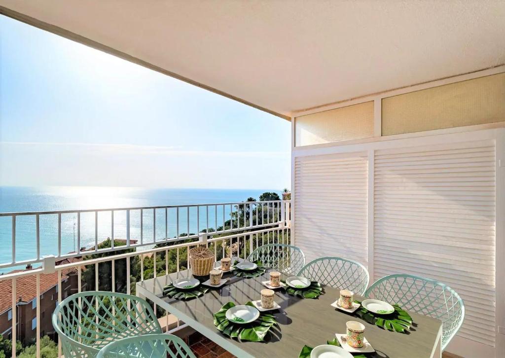 a table and chairs on a balcony with the ocean at LIANA SEAVIEW & BEACH - apartment in Montgat