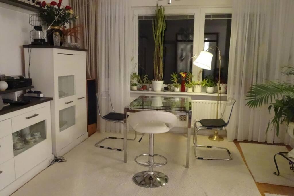 a kitchen with a glass table and two chairs at Schöne, ruhige Wohnung in Berlin-Steglitz in Berlin