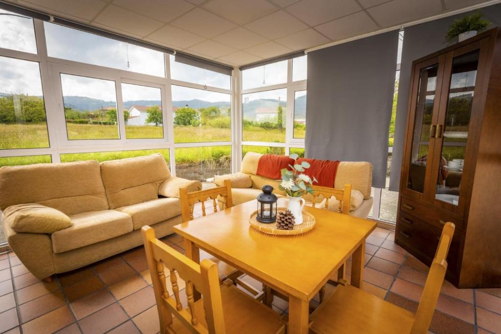 a living room with a table and a couch at Apartamentos Pumarin in Santa Marina