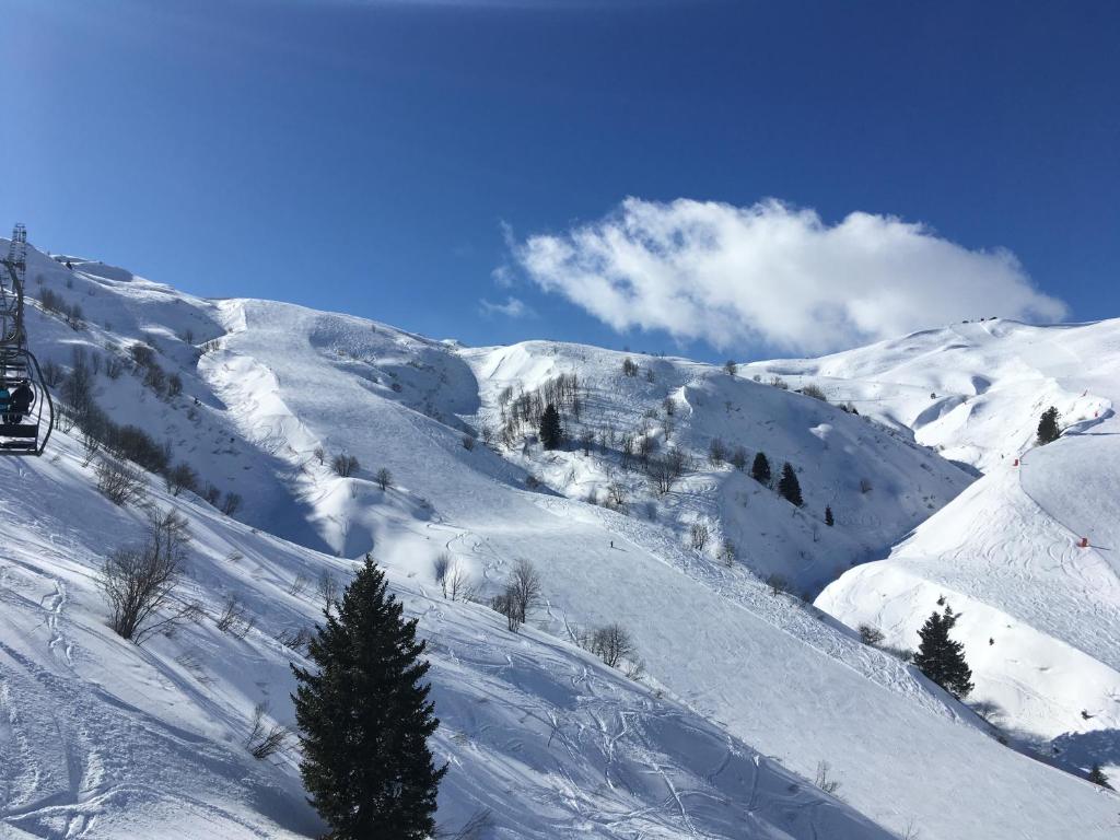 a snow covered mountain with a ski lift at les Cimes d'Or Mont blanc in Les Contamines-Montjoie