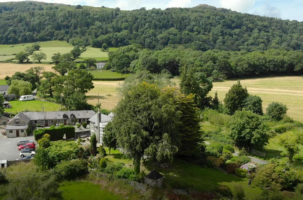 an aerial view of a house in a field with trees at Snowdonia Holiday Cottages in Conwy