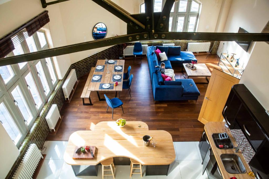 an overhead view of a living room with a couch and tables at Post Office Penthouse in Great Yarmouth