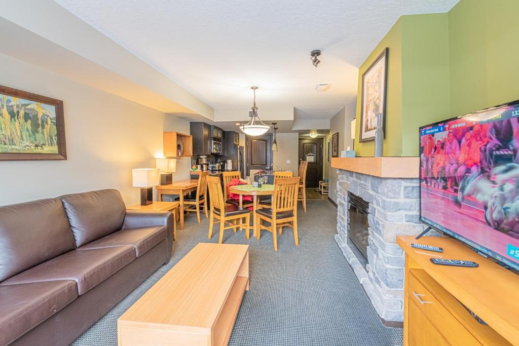 a living room with a couch and a fireplace at Copperstone Resort - Mountain View 2 Bedroom Condo in Canmore