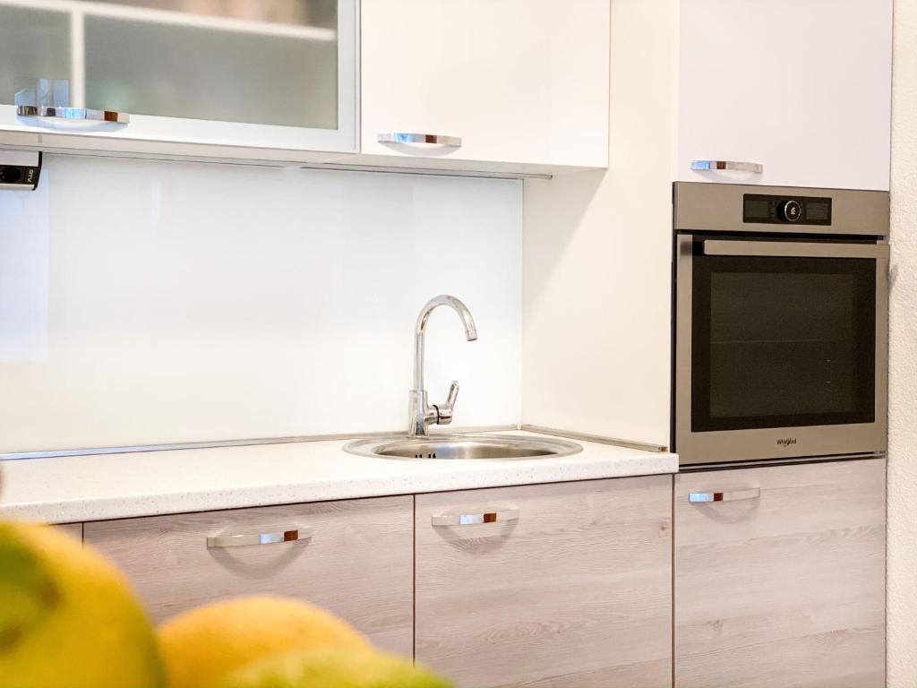 a kitchen with a sink and a microwave at Apartman Zorka in Povlja