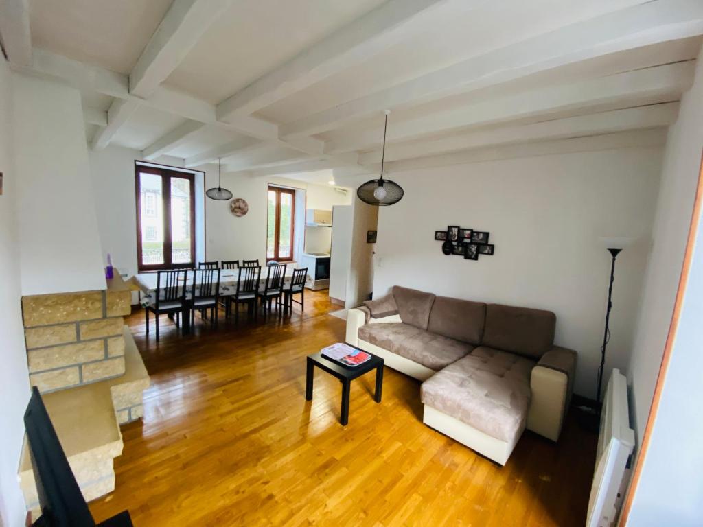 a living room with a couch and a table at Résidence Les Pâquerettes N3 in Le Mont-Dore