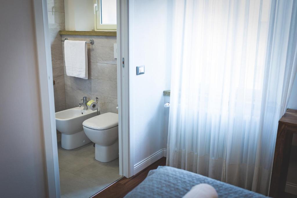 a bathroom with a toilet and a sink at Piazza Duomo Deluxe in Cecina