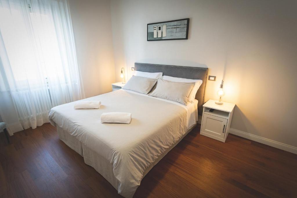 a bedroom with a bed with two towels on it at Piazza Duomo Deluxe in Cecina
