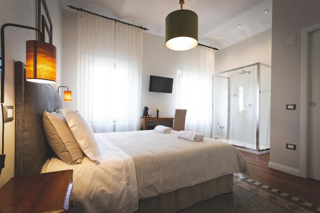 a bedroom with a large white bed in a room at Piazza Duomo Deluxe in Cecina